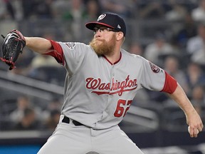 In this Wednesday, June 13, 2018 file photo, Washington Nationals relief pitcher Sean Doolittle delivers to the New York Yankees during the ninth inning of a baseball game at Yankee Stadium in New York.
