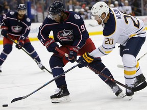 Columbus Blue Jackets' Anthony Duclair, left, and Buffalo Sabres' Scott Wilson chase the puck during the third period of a preseason NHL hockey game Monday, Sept. 17, 2018, in Columbus, Ohio. (AP Photo/) ORG XMIT: OHJL109