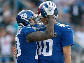 Odell Beckham Jr. congratulates teammate Eli Manning of the New York Giants during a game against the Carolina Panthers at Bank of America Stadium on October 7, 2018 in Charlotte, N.C. (Grant Halverson/Getty Images)