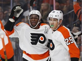 Philadelphia Flyers' James van Riemsdyk, right, celebrates after Wayne Simmonds, center, scored against the Vegas Golden Knights during the first period of an NHL game Thursday, Oct. 4, 2018, in Las Vegas.