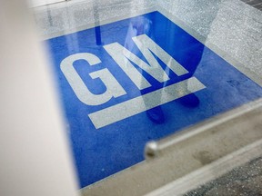 In this Jan. 10, 2013, file photo, the logo for General Motors decorates the entrance at the site of a GM information technology center in Roswell, Ga.