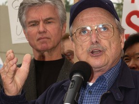 William Daniels (R) speaks as actor Kent McCord looks on at a rally against a proposed merger between the Screen Actors Guild (SAG) and the American Federation of Television and Radio Artists (AFTRA) at SAG headquarters June 4, 2003 in Los Angeles, California. (Photo by Vince Bucci/Getty Images)