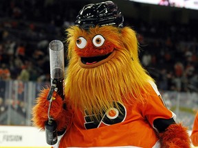 In this Sept. 24, 2018, file photo, the Philadelphia Flyers mascot, Gritty, takes to the ice during the first intermission of the Flyers' preseason game against the Boston Bruins, in Philadelphia.  (AP Photo/Tom Mihalek, File)