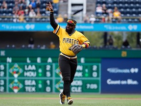 In this Sept. 23, 2018, file photo, Pittsburgh Pirates second baseman Josh Harrison acknowledges the fans as he leaves the field at PNC Park after being replaced in the eighth inning of the team's baseball game against the Milwaukee Brewers in Pittsburgh.