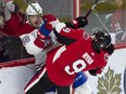 The Senators’ Bobby Ryan collides along the boards with Noah Juulsen of the Habs during Saturday night’s game.
