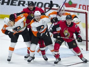 Philadelphia Flyers goaltender Calvin Pickard looks for the puck past Ottawa Senators right wing Bobby Ryan (9) and left wing Alex Formenton (59) as they battle with Flyers' defenseman Robert Hagg (8) and defenseman Andrew MacDonald (47) during second period NHL action Wednesday October 10, 2018 in Ottawa.