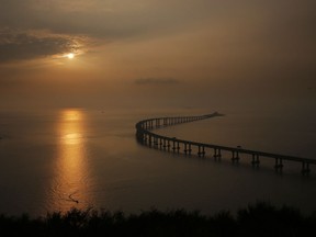 The Hong Kong-Zhuhai-Macau Bridge is seen against the sunset in Hong Kong, Monday, Oct. 22, 2018. The bridge, the world's longest cross-sea project, which has a total length of 55 kilometers (34 miles), will have opening ceremony in Zhuhai on Oct. 23.