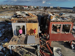 Bela (left) and Jaques Sebastiao begin the process of cleaning up their home after after it was heavily damaged by Hurricane Michael, on October 17, 2018 in Mexico Beach, Florida. (Joe Raedle/Getty Images)