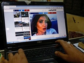 In this Monday, Oct. 1, 2018 photo, a fan of slain former beauty queen, fashion model and social media star Tara Fares follows the news after her assassination, at a shop in Baghdad, Iraq. Fares won fame in conservative, Muslim-majority Iraq with outspoken opinions on personal freedom. Last week, she was shot and killed at the wheel of her white Porsche on a busy Baghdad street. The violence reverberated across Iraq and follows the slaying of a female activist in the southern city of Basra and the mysterious deaths of two well-known beauty experts.