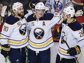 In this Jan. 22, 2018, file photo, Buffalo Sabres' Jack Eichel, centre, celebrates his game-winning goal during overtime against the Flames, in Calgary. (THE CANADIAN PRESS/Jeff McIntosh)