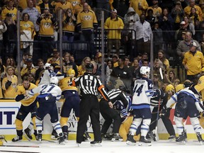 Several fights go on at once during the Jets-Predators game last night in Nashville, Tenn. The two teams combined for 76 penalty minutes. AP