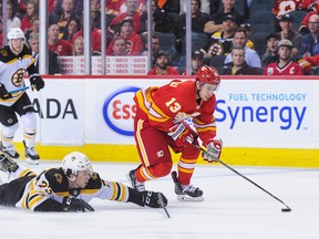 Flames' Johnny Gaudreau carries the puck past Charlie McAvoy of the Boston Bruins during Wednesday's game in Calgary. (GETTY IMAGES)