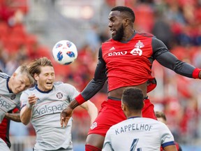 Toronto FC’s Jozy Altidore battles for the ball during a game against the Chicago Fire in July. The designated player hinted he is prepared to possibly play elsewhere next season, should the Reds decide to move him in an effort to pare down the team’s league-high salary. (THE CANADIAN PRESS/FILE)