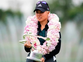 Danielle Kang of the U.S. poses with her trophy after winning the Shanghai LPGA golf tournament in Shanghai on Oct. 21, 2018.