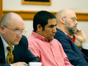 Zachary Koehn, centre, is flanked by attorneys Les Blair III and Steven Drahozal, as he sits in court Tuesday, Oct. 30, 2018 in Mount Pleasant, Iowa.