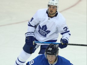 Leafs’ Auston Matthews (back) and Jets’ Patrik Laine watch for the play to develop during Wednesday’s game in Winnipeg. Laine has struggled to find the scoresheet with regularity out of the gate, while Matthews leads the league with 10 goals and 16 points. (KEVIN KING/POSTMEDIA NETWORK)