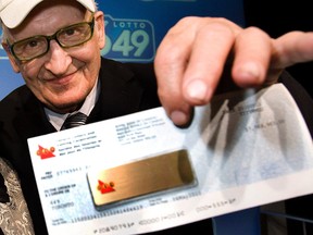 Peter Kaczmarczyk collecting his cheque after his 2010 Lotto 6/49 win.