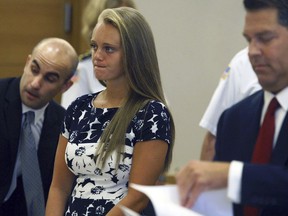 In this July 29, 2016, file photo, Michelle Carter stands with her attorneys at the Bristol County Juvenile Court in Taunton, Mass.