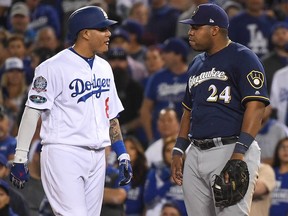 Manny Machado of the Los Angeles Dodgers and Jesus Aguilar of the Milwaukee Brewers exchange words during Game 4 of the National League Championship Series at Dodger Stadium on October 16, 2018 in Los Angeles. (Harry How/Getty Images)