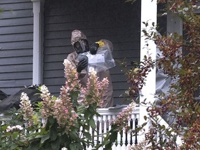 A person in a hazmat suit appears to be handling a letter that is enclosed in a plastic bag in Bangor, Maine, Monday, Oct. 15, 2018.