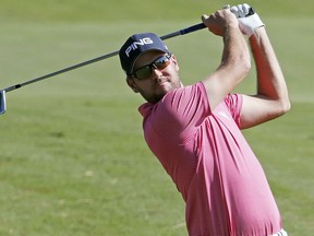 Corey Conners of Canada, watches his approach drive on the 18th fairway during the third day of the Sanderson Farms Championship golf tournament in Jackson, Miss., Saturday, Oct. 27, 2018.