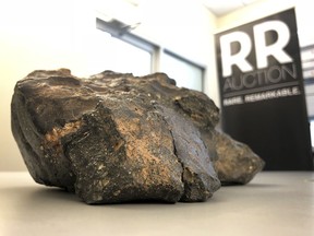 A 12-pound (5.5 kilogram) lunar meteorite discovered in Northwest Africa in 2017 rests on a table, in Amherst, N.H.