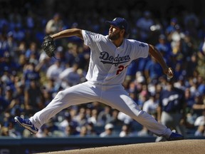 Dodgers starting pitcher Clayton Kershaw throws during the first inning of Game 5 of the National League Championship Series against the Brewers Wednesday, Oct. 17, 2018, in Los Angeles.