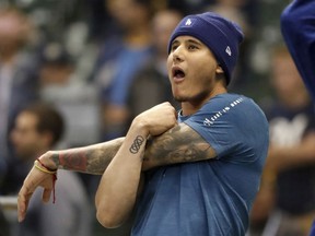 Los Angeles Dodgers' Manny Machado stretches as he takes batting practice before Game 6 of the National League Championship Series baseball game against the Milwaukee Brewers Friday, Oct. 19, 2018, in Milwaukee.