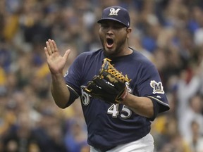 Milwaukee Brewers starting pitcher Jhoulys Chacin reacts after Colorado Rockies' Trevor Story strikes out during the first inning of Game 2 of the National League Divisional Series baseball game Friday, Oct. 5, 2018, in Milwaukee.