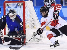 United States goaltender Madeline Rooney (35) makes a save on Canada forward Blayre Turnbull (40) during during the 2018 Olympic Games in Gangneung, South Korea on Thursday, February 22, 2018.