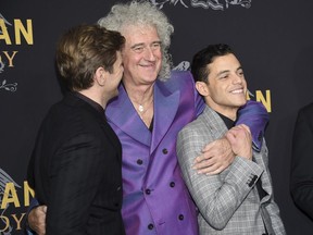 Musician Brian May, center, poses with actors Allen Leech, left, and Rami Malek at the premiere of "Bohemian Rhapsody" at The Paris Theatre on Tuesday, Oct. 30, 2018, in New York.