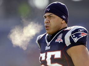 In this Jan. 10, 2010, file photo, New England Patriots linebacker Junior Seau (55) warms up on the field in Foxborough, Mass.