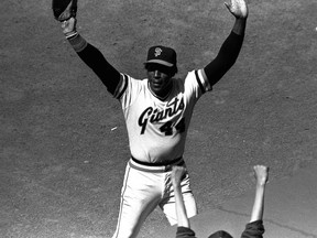 In this July 3, 1980, file photo, San Francisco Giants' Willie McCovey raises his hands in salute to the cheering crowd after he was replaced in the lineup in the team's baseball game with the Cincinnati Reds in San Francisco.