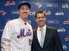 In this Wednesday, Feb. 7, 2018, file photo, New York Mets newly-signed third baseman Todd Frazier, left, poses for photographers with his agent, Brodie Van Wagenen, after the former New York Yankees third baseman signed with the Mets, in New York.