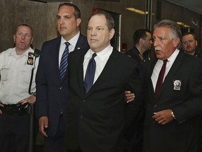 In this July 9, 2018 file photo, Harvey Weinstein is escorted in handcuffs to a courtroom in New York.