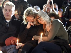 Family members and friends gather for a candlelight vigil memorial at Mohawk Valley Gateway Overlook Pedestrian Bridge in Amsterdam, N.Y., Monday, Oct. 8, 2018. The memorial honored 20 people who died in Saturday's fatal limousine crash in Schoharie, N.Y.