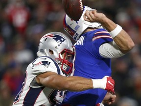 Buffalo Bills quarterback Derek Anderson, right, fumbles the ball on a hit by New England Patriots linebacker Kyle Van Noy during the second half of an NFL football game, Monday, Oct. 29, 2018, in Orchard Park, N.Y.