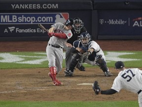 Boston Red Sox's Brock Holt connects for a two-run triple against the New York Yankees during the fourth inning of Game 3 of baseball's American League Division Series, Monday, Oct. 8, 2018, in New York.