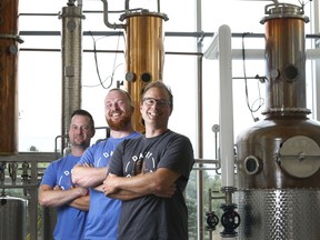 Anthony Seed, head of sales, Neal McCarten, director of operations, and Omid McDonald, CEO, pose for a photo at Dairy Distillery in Almonte. Tony Caldwell/Postmedia