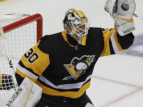 Pittsburgh Penguins goaltender Matt Murray gloves a shot in the third period of an NHL hockey game against the Montreal Canadiens in Pittsburgh, Saturday, Oct. 6, 2018.