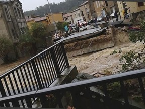 This photo provided by Stephane Jourdain, after a torrent of water ripped out the bridge in Villegailhenc, southern France, Monday Oct. 15, 2018. Flash floods have left several people dead in southwest France, with roads swept away and streams become raging torrents as the equivalent of several months of rain fell overnight, authorities said Monday.