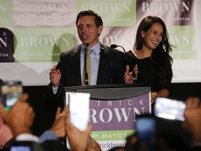 Patrick Brown flanked with his wife Genevieve is ushered in as the new mayor of Brampton Monday October 22, 2018. Jack Boland/Toronto Sun/Postmedia Network