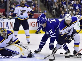 Blues goalie Jake Allen (34) looks on as Maple Leafs centre Patrick Marleau (12) fails to get the rebound and Blues defenceman Alex Pietrangelo (27) tries to clear the puck during third period NHL action in Toronto on Saturday, Oct. 20, 2018.