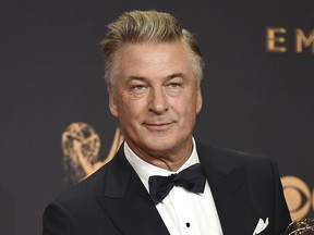 FILE - In this Sept. 17, 2017 file photo, Alec Baldwin poses in the press room with the award for outstanding supporting actor in a comedy series for "Saturday Night Live" at the 69th Primetime Emmy Awards in Los Angeles. Baldwin says voters should see the Nov. 6 midterm elections as an opportunity to peacefully "overthrow the government of Donald Trump." Baldwin spoke Sunday night, Oct. 14, 2018, at a fundraising dinner for the New Hampshire Democratic Party a night after returning to "Saturday Night Live" to portray the president.