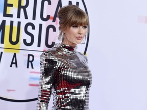 FILE - In this Oct. 9, 2018, file photo, Taylor Swift arrives at the American Music Awards at the Microsoft Theater in Los Angeles. Swift has donated $15,500 to a GoFundMe account of a fan whose family is struggling with medical bills.