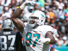 Jordan Phillips #97 of the Miami Dolphins celebrates after the touchdown during the first quarter against the Oakland Raiders at Hard Rock Stadium on Sept. 23, 2018 in Miami.