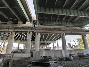 This Sunday, Oct. 28, 2018 photo shows a view of the scene where Ricardo Davis, a Washington Park auxiliary officer fell through the opening of the bridge and landed underneath the Poplar Street Bridge on the Illinois side of the Mississippi River. Davis died after he fell from the bridge while chasing a suspect on Saturday, Oct. 27. Bridge construction and reinforcement is ongoing. (J.B. Forbes/St. Louis Post-Dispatch via AP) ORG XMIT: MOSTP804