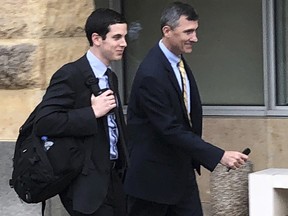 U.S. Attorney Gregory Bernstein, left, and FBI Special Agent Keith Custer walk outside the federal courthouse, Thursday, Oct. 11, 2018, in Greenbelt, Md. (AP Photo/Michael Kunzelman)