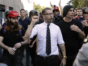 In this April 27, 2017 file photo, Gavin McInnes, centre, founder of the far-right group Proud Boys, is surrounded by supporters after speaking at a rally in Berkeley, Calif.