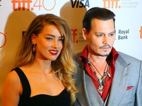 Johnny Depp with his wife Amber Heard on the red carpet for movie "Black Mass" during the Toronto International Film Festival in Toronto on Friday September 11, 2015. Dave Abel/Toronto Sun/Postmedia Network